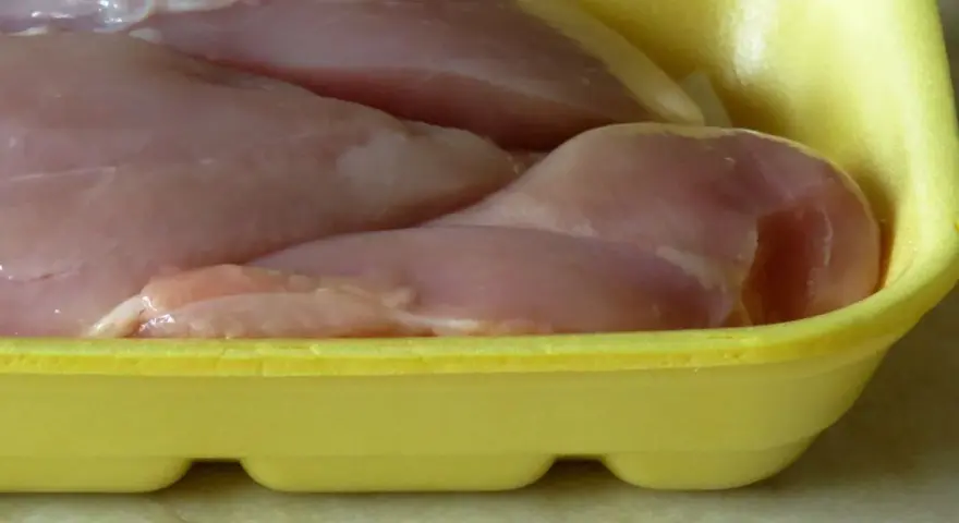 Surowe mięso drobiowe w żółtej tacce. Po zużyciu, gdzie wyrzucać plastikowe opakowania po mięsie? Do plastiku.